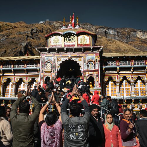 Crowd of devotees gathered at Badrinath Temple, India, embracing spirituality.